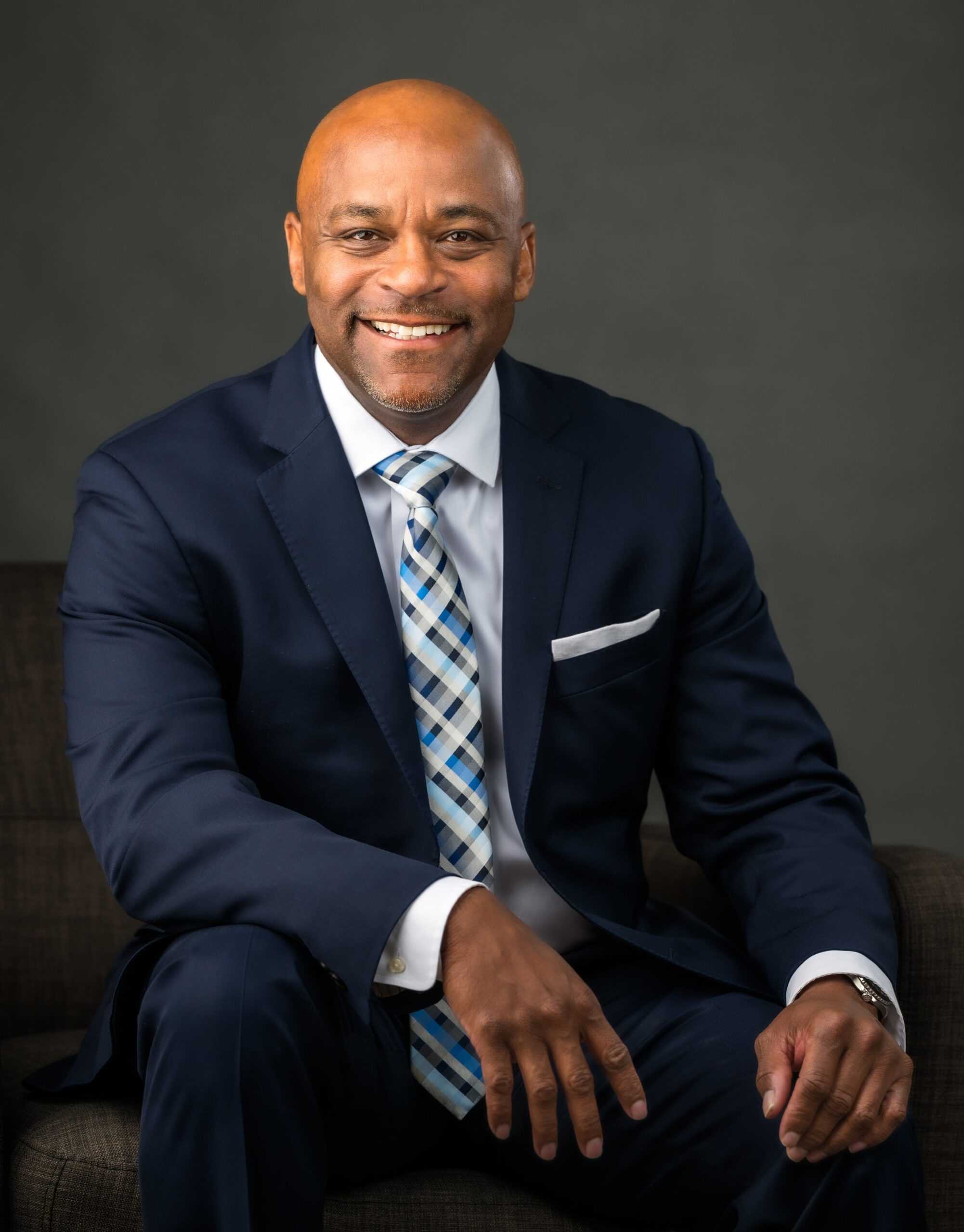 michael hancock sitting wearing suit and tie